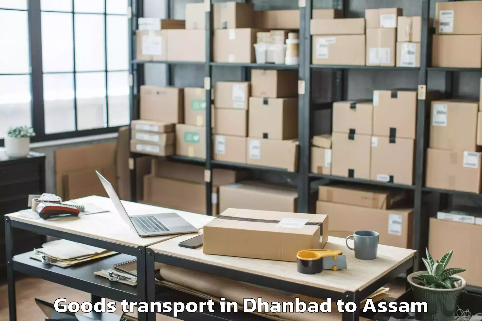 Book Dhanbad to Banekuchi Goods Transport